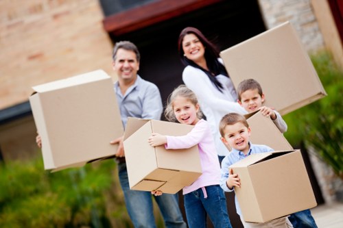 Professional movers handling office equipment